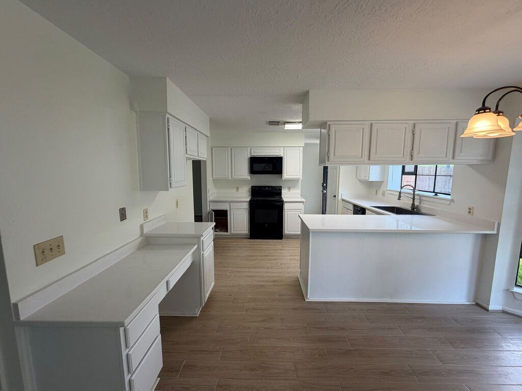 Fresh white quartz counters in a vacant-unit kitchen turn
